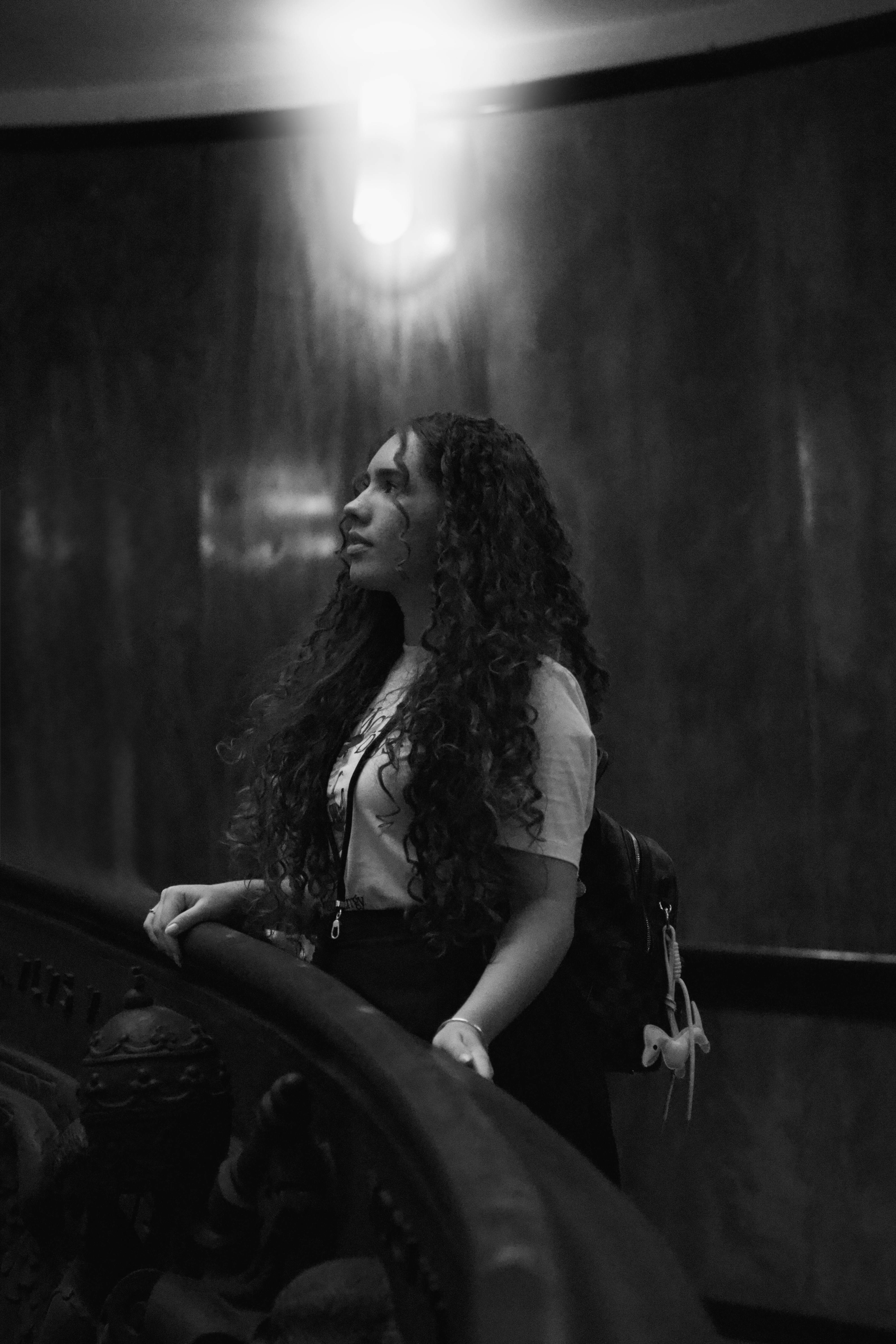 Retrato de Beatriz sentada em ambiente interno preto e branco